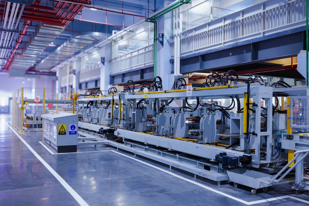 A modern manufacturing facility featuring robotic machinery and industrial equipment in a well-lit space.